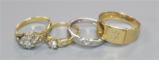 Three assorted 18ct gold and diamond rings and a white metal and solitaire diamond ring.